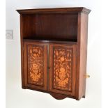 A 19th century walnut and marquetry hanging cabinet the flared cornice over an open shelf and pair