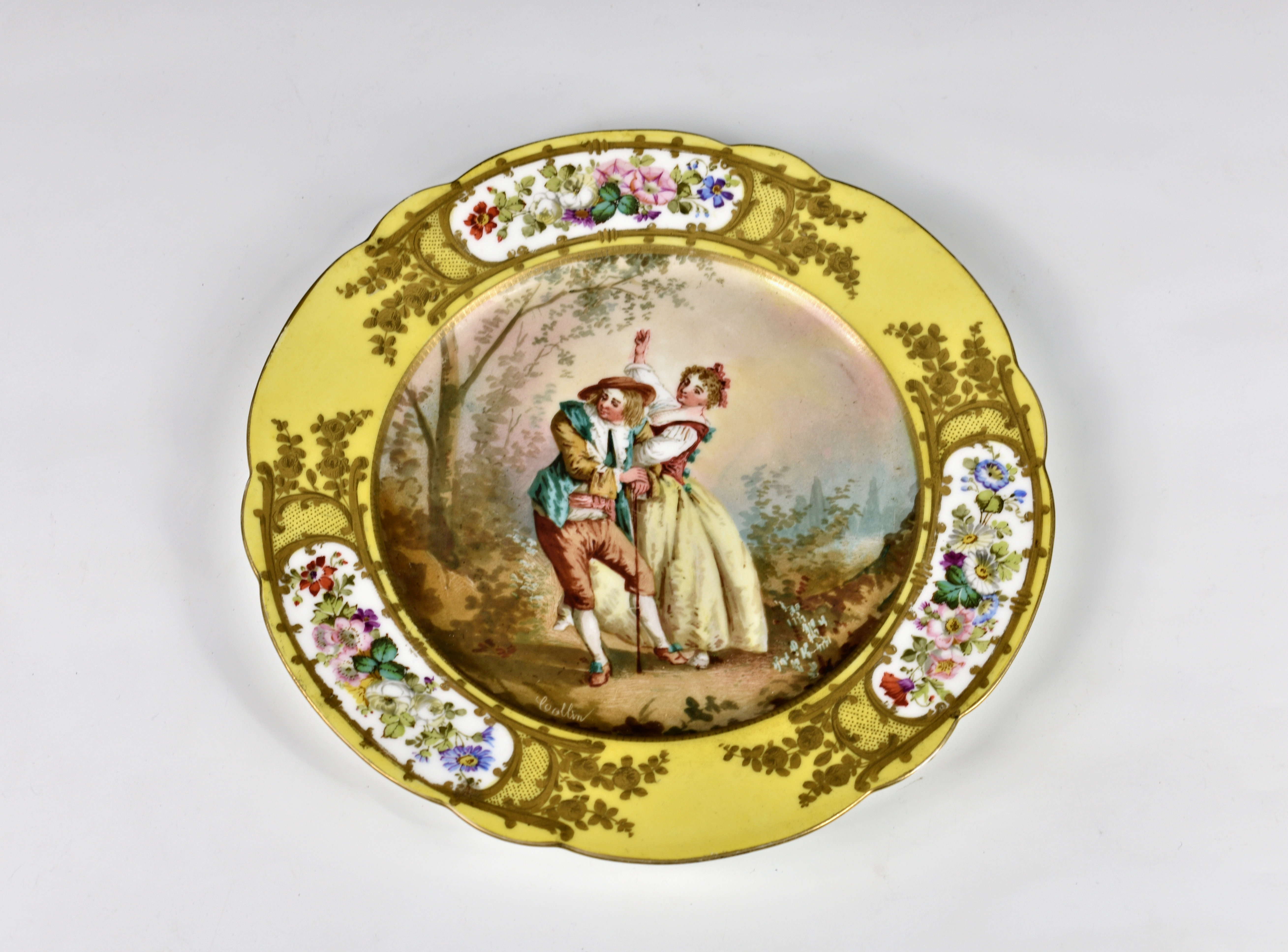 A late 19th / early 20th century yellow ground Sèvres cabinet plate with shaped rim, the centre with