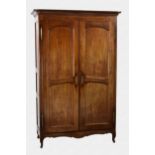 A late 18th / early 19th century French fruitwood armoire with a moulded cornice and two, two-