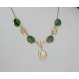 A Chinese 14ct gold and jade necklet with four oval polished green jade stones divided by and