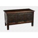 A late 17th century carved oak coffer the two plank top with thumb moulded edge, on the original