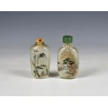 Two Chinese interior painted glass snuff bottles one painted with figures at a tree-lined lakeside