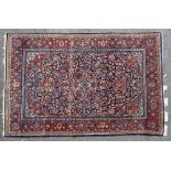 A Kashan rug second quarter 20th century, dark blue field with central madder floral pendant