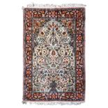 A Kashmiri silk vase design rug the ivory Mihrab with flowering vines issuing from a vase, below