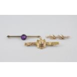 An 18ct gold eagle bar brooch together with two 9ct gold bar brooches, one with a pair of
