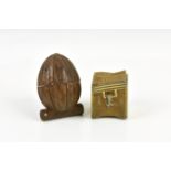 A novelty carved wood thimble case with Stanhope fashioned as a walnut the walnut sitting on a