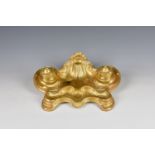 A French rococo style gilded white metal inkstand late 19th / early 20th century, the shaped base