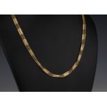 A 9ct yellow gold three strand necklace with bar and bead links, 17in. (43cm.) long.