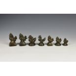 Seven antique Burmese or Chinese bronze gold or opium weights five in the form of a Chinthe; three