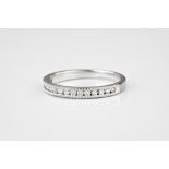 A platinum and diamond half eternity ring channel set with sixteen brilliant cut diamonds within