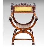 A Continental carved walnut x-frame armchair late 19th century, the foliate, grotesque mask and