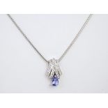 A 9ct gold, Tanzanite & diamond pendant necklace the pear cut Tanzanite below a diamond set fan,
