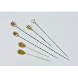 Three 9ct rose gold Art Nouveau style hatpins late 19th / early 20th century, one with a single