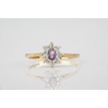 A 9ct gold, amethyst and CZ cluster ring size L.