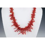 A vintage coral fringe necklace 1930s; together with an amber bead necklace; and a hardstone