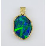 A fine 18ct gold and black opal pendant the oval 29 x 21mm. opal of fine colour and iridescence,