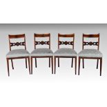 A good set of four Regency mahogany, ebonised and brass dining chairs the brass strung backs with