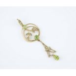 An Edwardian 9ct gold, peridot and seed pearl Art Nouveau style pendant the openwork pendant with