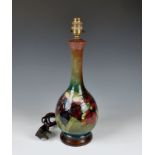 A Walter Moorcroft Orchid pattern lamp base of baluster form, tube lined with flower heads and