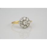 A Victorian 18ct gold and diamond floral cluster ring the central cushion cut diamond within a