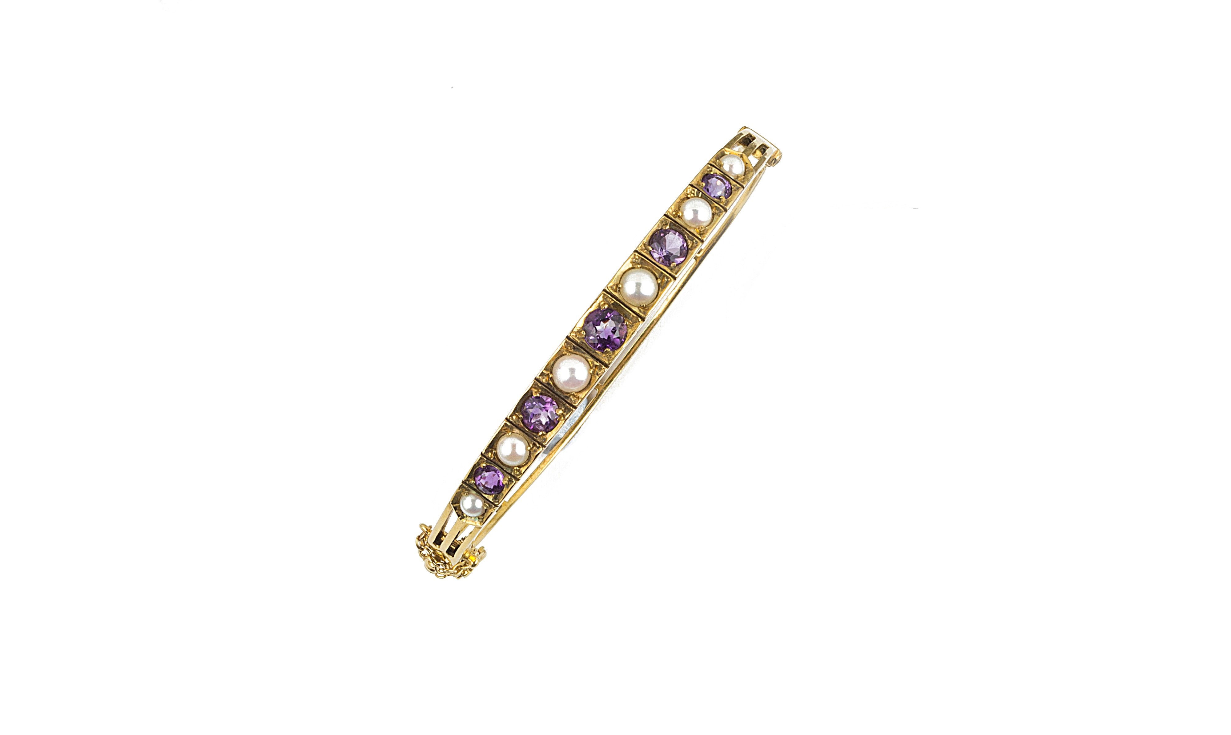 NINE CARAT GOLD AMETHYST AND PEARL BANGLE 1970s the hinged bangle set to the front with graduated