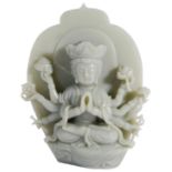 A CHINESE CELADON JADE FIGURE OF GUANYIN the eight-armed deity seated in front of a lotus-shaped