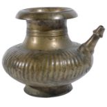 A BRASS SPOUTED WATER POT (LOTA), DECCAN, SOUTHERN INDIA, 18TH/19TH CENTURY the bulbous ribbed