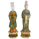 A PAIR OF CHINESE SANCAI GLAZED POTTERY FIGURES OF ATTENDANTS, MING DYNASTY (1368-1644) standing