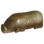 A CHINESE ARCHAISTIC JADE PIG carved as a recumbent animal, the stone of olive-green tone 12.5cm