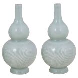 A PAIR OF CHINESE CELADON GLAZED PORCELAIN VASES, 19TH CENTURY double gourd form beneath slender