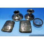 Two hallmarked silver cigarette cases, Birmingham 1912 & 1919, 5 oz.; a silver dwarf candlestick;