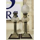 A pair of EPNS and cut glass oil lamps with reeded columns, square velvet covered bases,