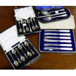 A set of silver thistle top coffee spoons, Birmingham 1954, cased; a similar dog nose set,