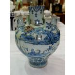 A 17th/18th Persian baluster tulip vase decorated in blue and white with river scenes, central