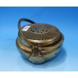 A circular Chinese covered incense burner with pierced lid and double hinged handle