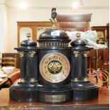 A black slate architectural mantel clock, with French 8 day striking movement, bears silver