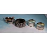 two silver napkin rings; a silver salt; a silver slave bangle (various dates) 4.5oz.; a pair of