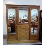 An Edwardian inlaid mahogany triple combination wardrobe with 2 mirrored side robes and central