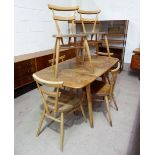 A 1950's Ercol elm and beech dining suite comprising rectangular drop leaf table and 6 bar back