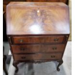 A 1920's figured mahogany Georgian style bureau with fall front and 3 drawers under