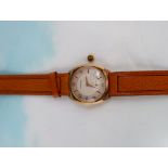 A 1950's/60's gent's 9 carat hallmarked gold wristwatch by Garrard, with alternating Arabic numerals