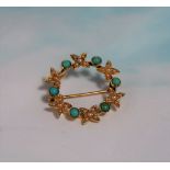 A yellow metal circular brooch set seed pearls and turquoise