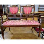 An Edwardian inlaid mahogany 2 seater settee upholstered in red / gilt fabric