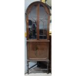 An early 20th century mahogany display cabinet, period style and corner fitting, with arch top,