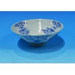 A Chinese porcelain blue and white rice bowl decorated with dragons exotic trees etc on raised foot,