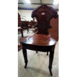 A Regency period hall chair with carved shield back; an Edwardian inlaid plant stand