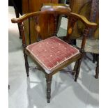 An Edwardian inlaid mahogany corner armchair on turned legs