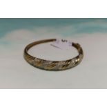 A 9 carat hallmarked gold hinged bracelet with gem set rope twist decoration, 13.2 gm (a.f.)