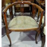 An Edwardian pair of mahogany tub shaped armchairs on cabriole legs