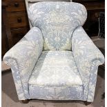 An Edwardian gent's arm chair upholstered in traditional blue cotton fabric